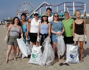 Volunteers take a break from a beach cleanup at the Santa Monica Pier